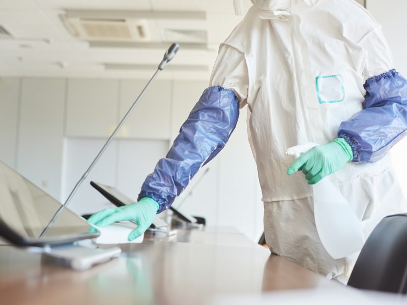 Worker Cleaning Office Table Close Up